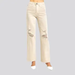 Distressed women's sand jeans